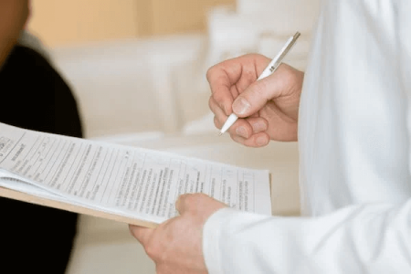 pexels doctor signing form.png