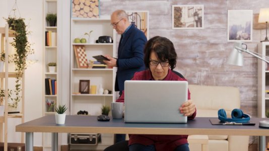 elderly-woman-opening-laptop-putting-his-glasses-her-face-old-man-with-glasses-using-tablet-br...jpg