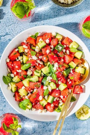 chopped cucumber, cubed watermelon, crumbled feta and shopped mint in a bowl.