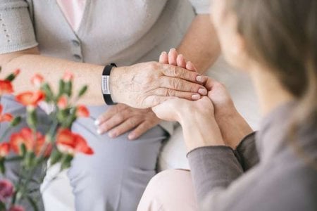 compressed-Caretaker-giving her-hand-medical bracelet.jpeg