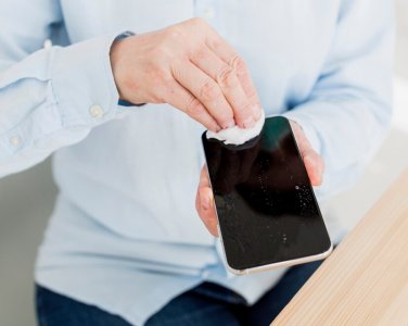 high-angle-elder-woman-disinfecting-her-smartphone_23-2148492282.jpg