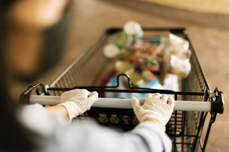 hand-wearing-latex-glove-while-pushing-shopping-cart-prevent-coronavirus-contamination_53876-1...jpg