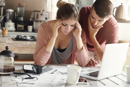 depressed-young-woman-having-bad-headache-holding-her-temples-feeling-stressed-by-lack-money-p...jpg