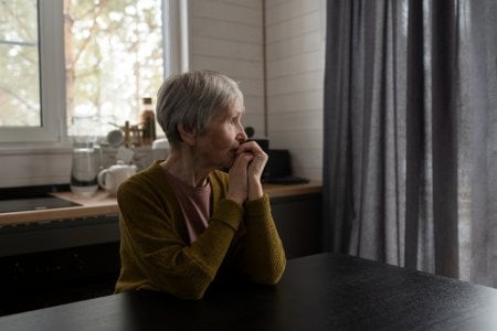 medium-shot-senior-woman-sitting-table.jpg