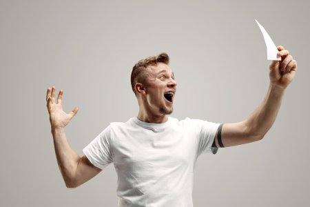 young-caucasian-man-with-surprised-happy-expression-won-bet-gray-studio-background-human-facia...jpg