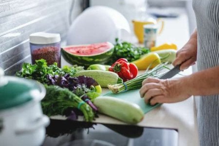 compressed-woman-cooking-vegetables-kitchen.jpeg