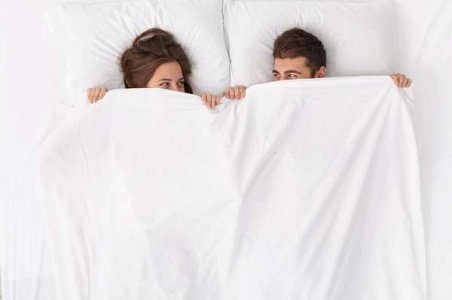 compressed-close-up-couple-lying-bed-white-blanket.jpeg