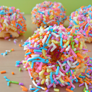 DALL·E 2022-10-20 10.08.33 - Rice pop doughnuts with sprinkles.png