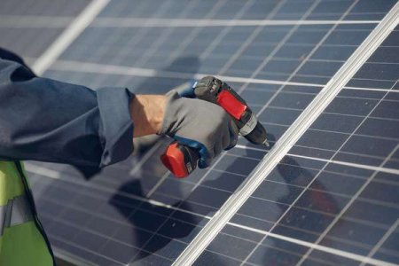compressed-man-with-white-helmet-near-solar-panel.jpeg
