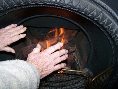 Mums arthritic hands warming by the fire. Cottage in York WA..jpg