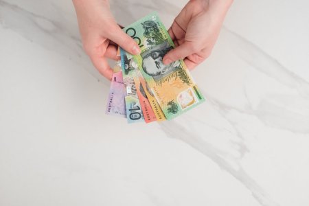 australian-dollar-banknotes-hands-white-background.jpg