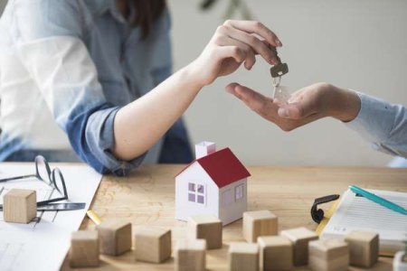 compressed-close-up-woman-s-hand-giving-house-key-man-wooden-table.jpeg