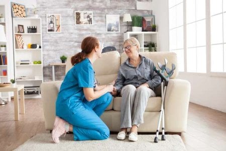 compressed-happy-old-woman-nursing-home-sitting-couch-talking-with-her-caretaker-retired-woma...jpeg