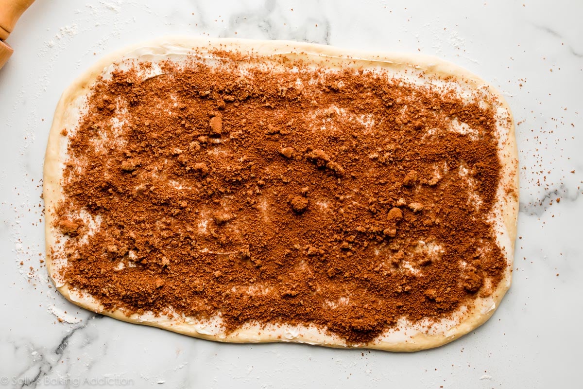 dough rolled out with butter, cinnamon and brown sugar on top