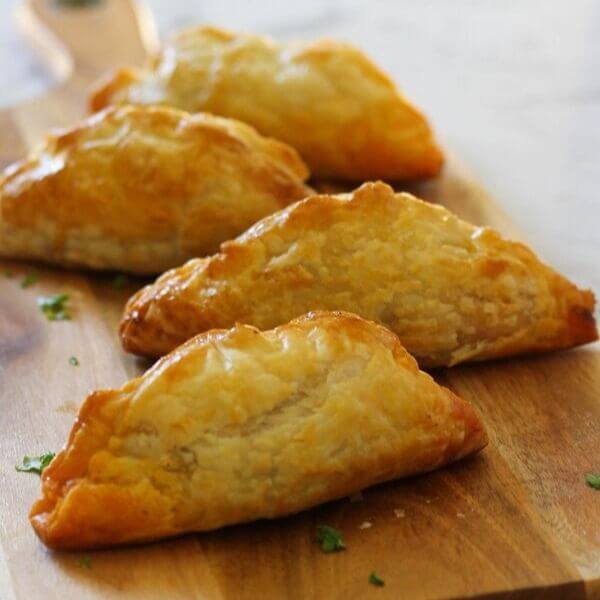 Beef Pasties on a wooden board.