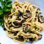 creamy vegan mushroom pasta with spaghetti and pasrley.