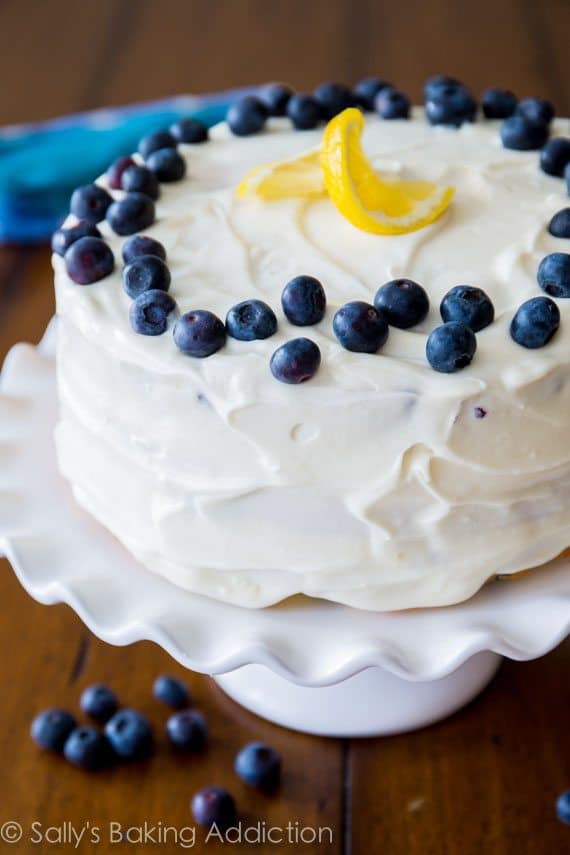 Lemon blueberry cake on a white cake stand