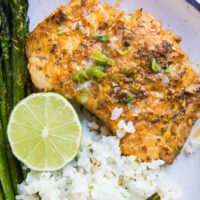 Plate of baked cod with asparagus and cauliflower rice. Ready to eat for dinner!