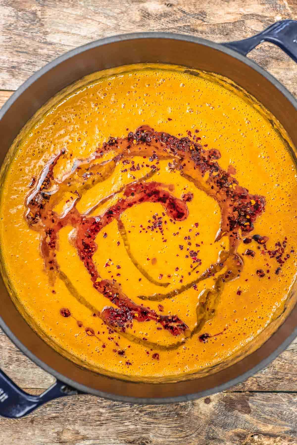 Turkish red lentil soup in a Dutch oven with warmed extra virgin olive oil drizzled on top.