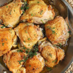 Overhead shot of Crispy Baked Chicken Thighs in a skillet.